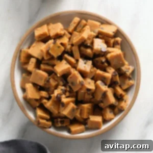 Peanut butter fudge with cookie dough bites in a bowl.