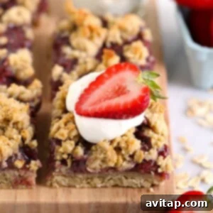 strawberry oatmeal bar topped with whipped cream and a fresh strawberry
