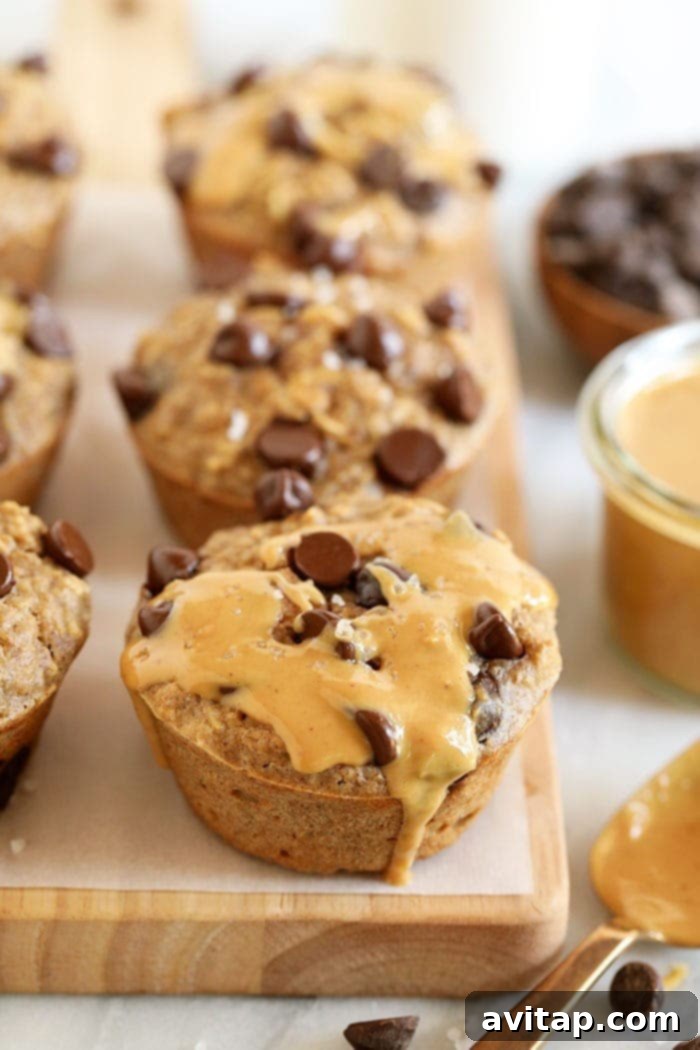 A single baked oatmeal cup with a swirl of peanut butter, showcasing its delightful texture and chocolate chips.