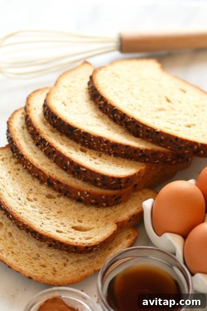 Effortless Baked French Toast 3 Whole wheat bread slices neatly arranged, ready to be transformed into delicious sheet pan French toast.
