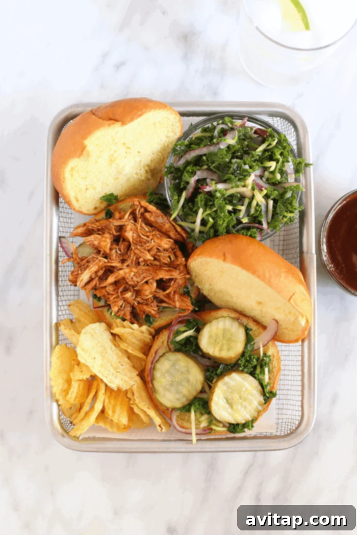 Slow cooker BBQ pulled chicken served in a basket with chips and slaw