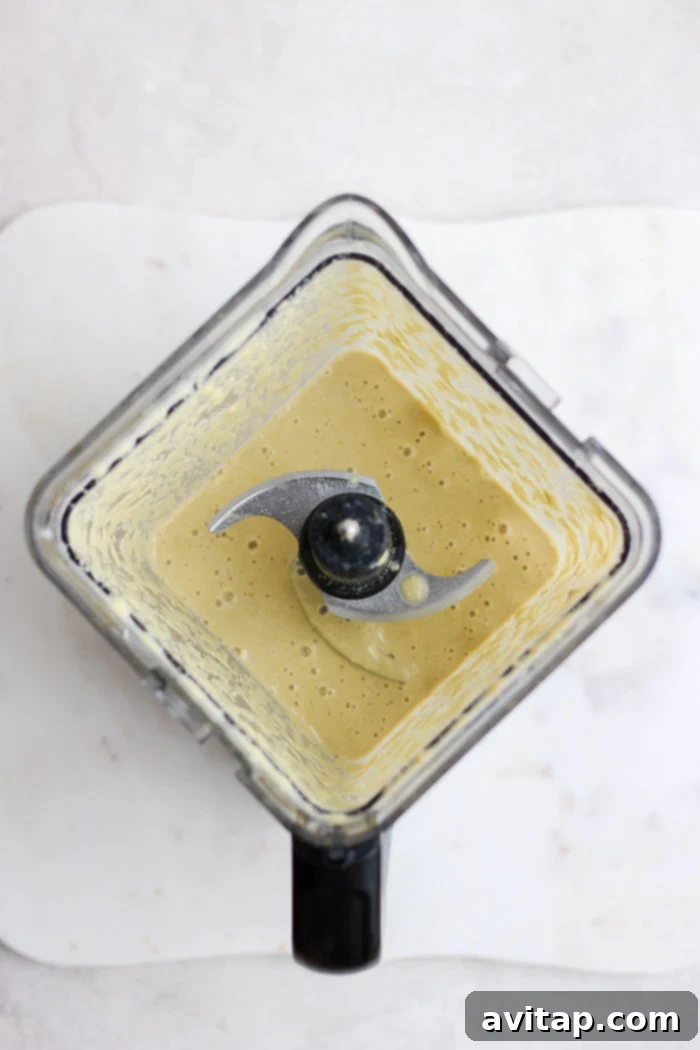The creamy cashew curry sauce being blended to perfection in a blender.