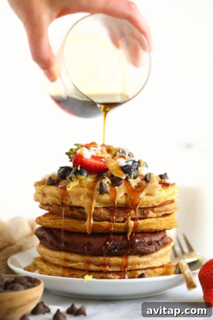 Delicious healthy pancakes stacked high with syrup, ready to be enjoyed. A stack of golden brown healthy pancakes drizzled with maple syrup.