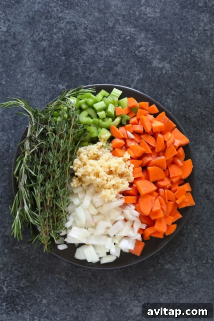 Fresh Ingredients for Homemade Chicken Noodle Soup Assortment of fresh ingredients for chicken noodle soup, including chicken breast, carrots, celery, onion, garlic, and fresh herbs.