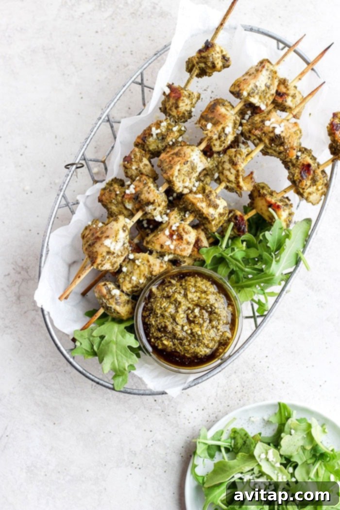 Easy Grilled Pesto Chicken Skewers: Your Go-To 2-Ingredient Recipe Juicy grilled pesto chicken skewers artfully arranged in a rustic basket, ready to be served.