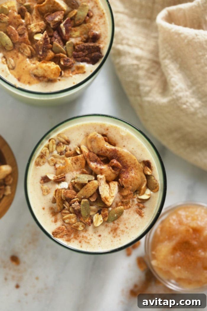 apple smoothie topped with nut butter and granola