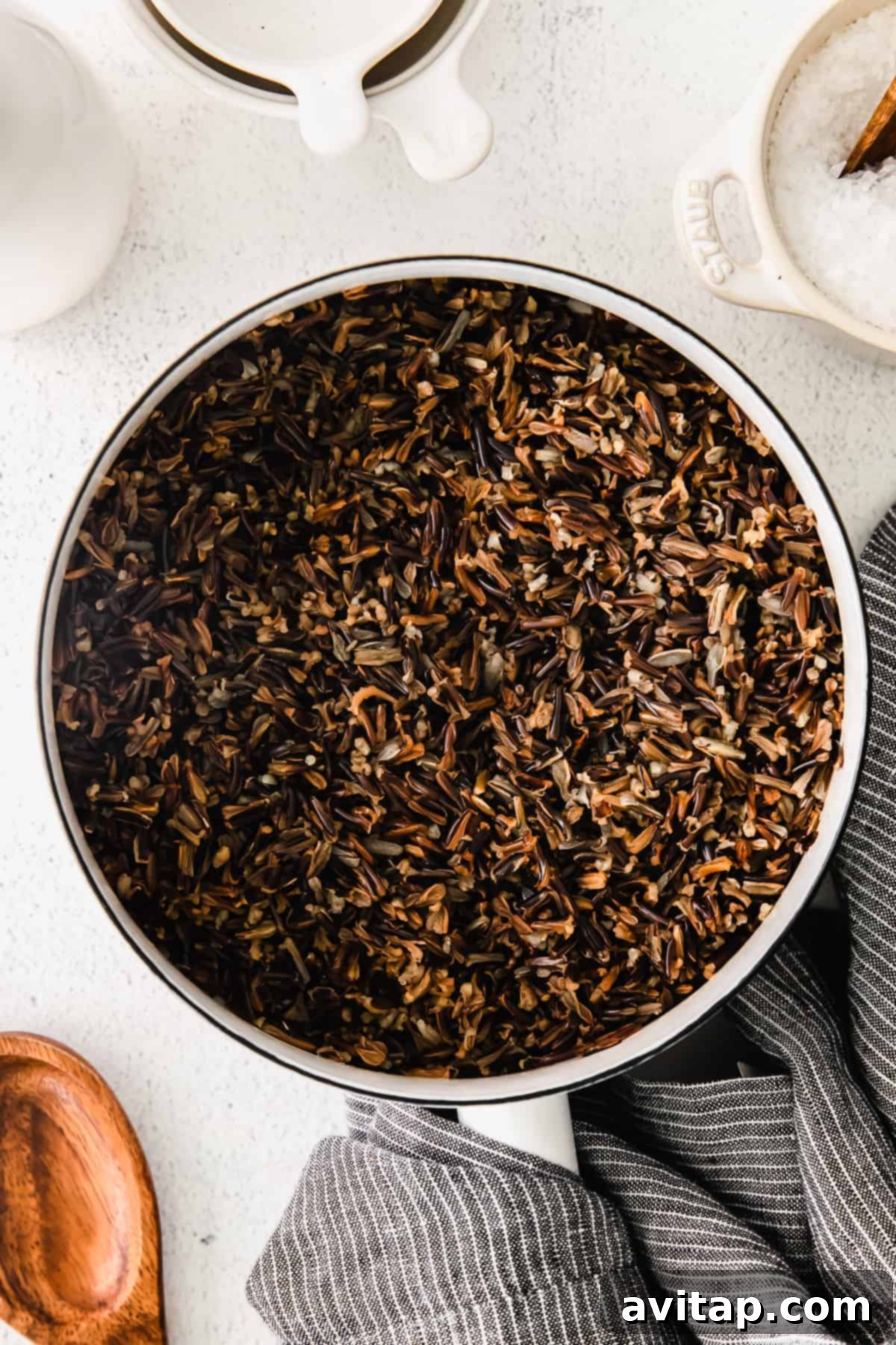 Steaming, perfectly cooked wild rice filling a large stock pot, ready to be dished out.