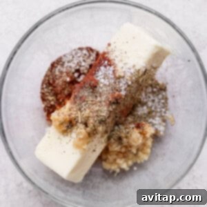 A glass bowl with a scoop of ice cream and spices resembling a whole roasted chicken.