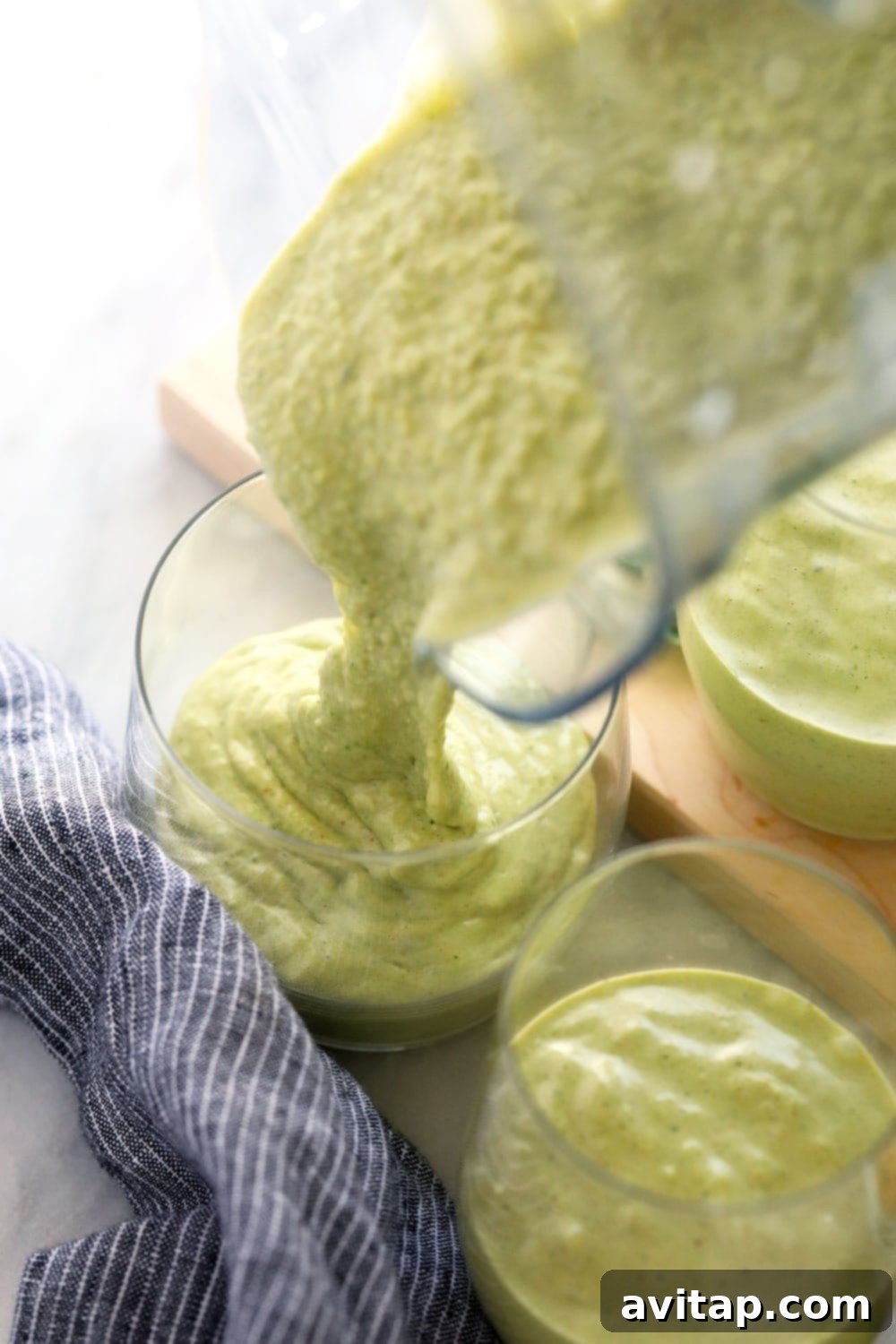 Peanut Butter Green Dream Smoothie 4 Peanut Butter Green Smoothie being poured into a tall glass, showing its creamy texture
