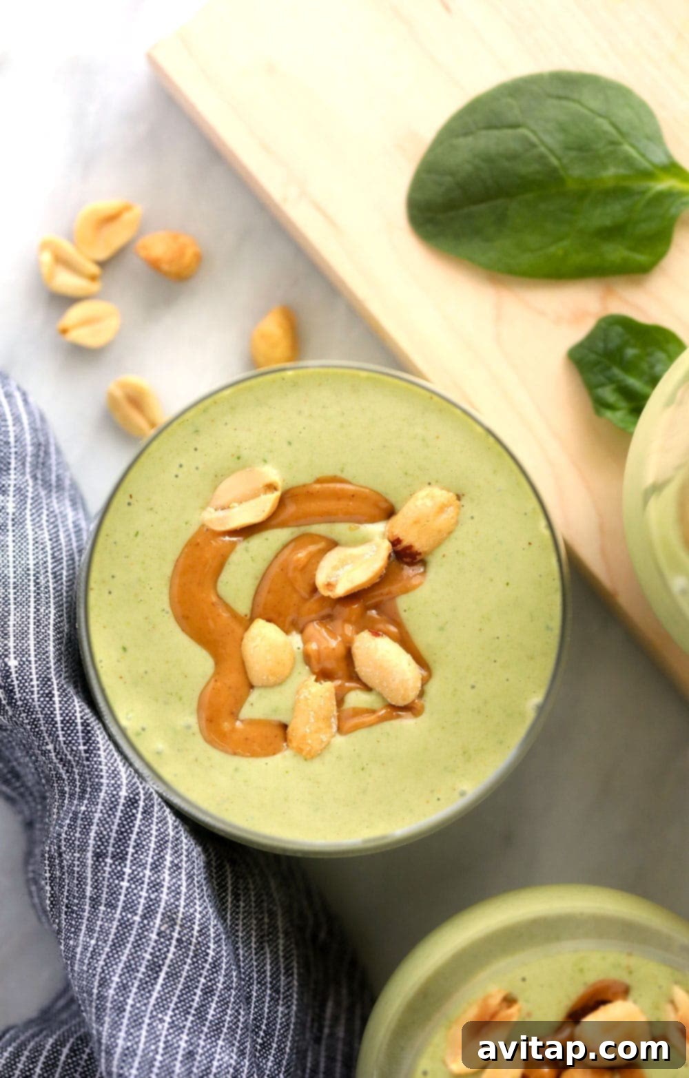 Peanut Butter Green Dream Smoothie 5 A single glass of Peanut Butter Green Smoothie topped with peanuts, presented beautifully