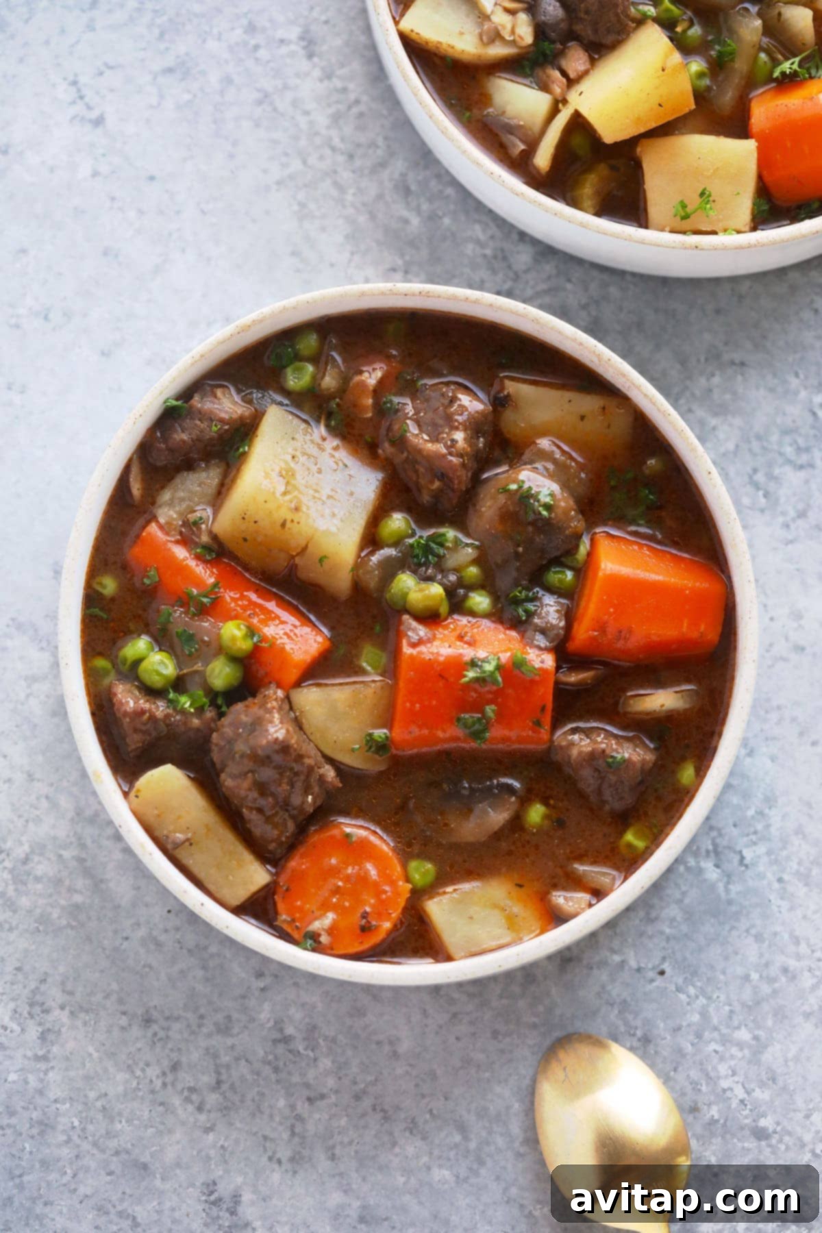 A hearty bowl of slow cooker beef stew, brimming with tender beef and colorful vegetables, ready to be enjoyed.