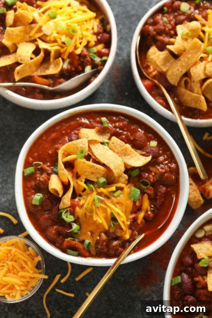 A close-up of a bowl of rich beef chili, perfectly topped with melted cheese.