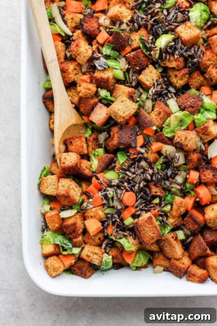 Golden-brown cornbread dressing in a ceramic baking dish, ready to serve.