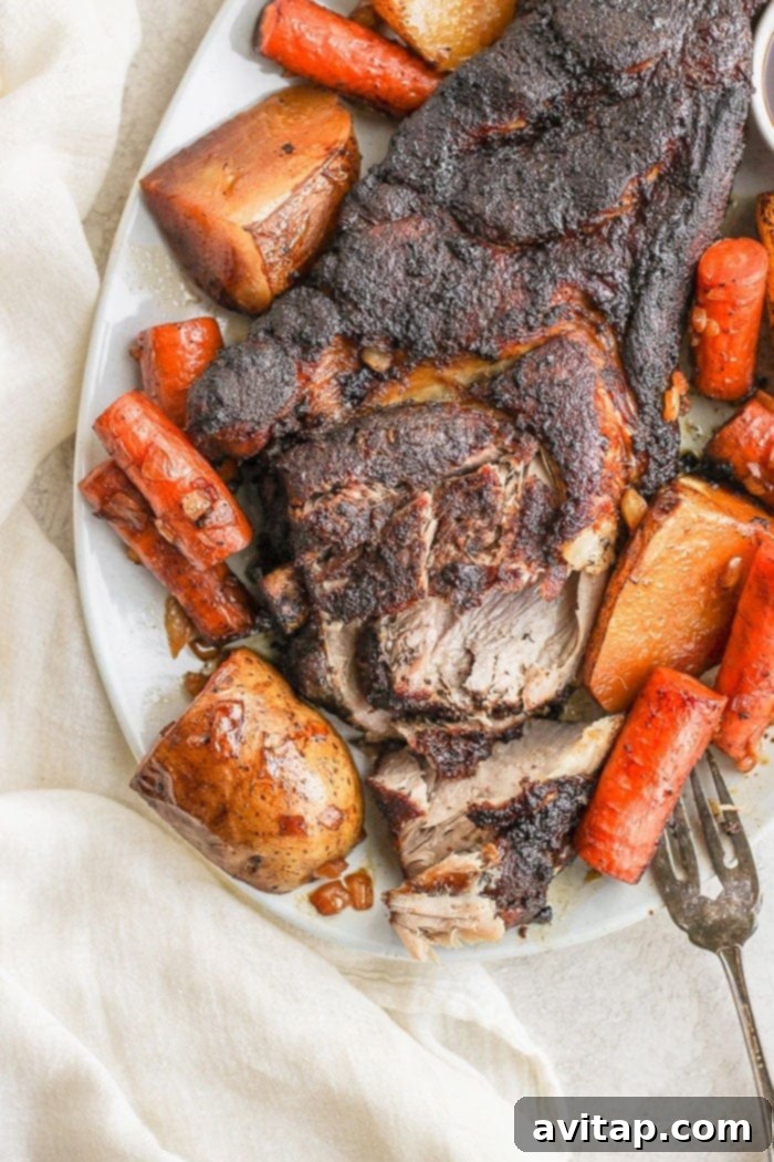 Generous serving of slow cooker pork roast on a large platter, ready to be served.