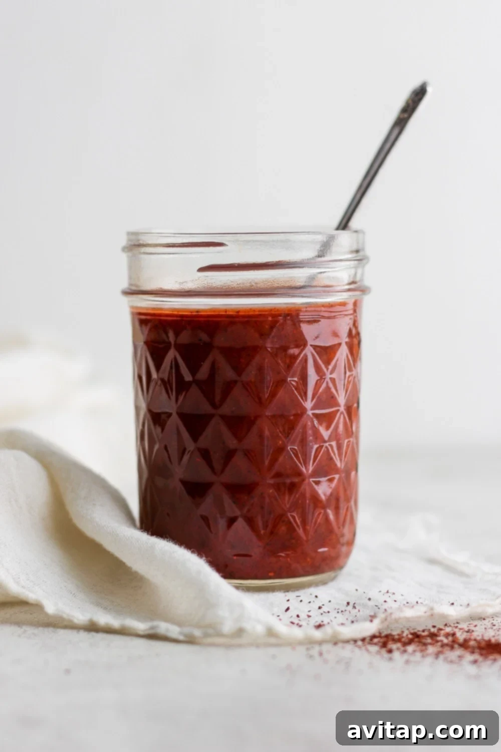 Freshly made homemade enchilada sauce in a glass jar, ready for use