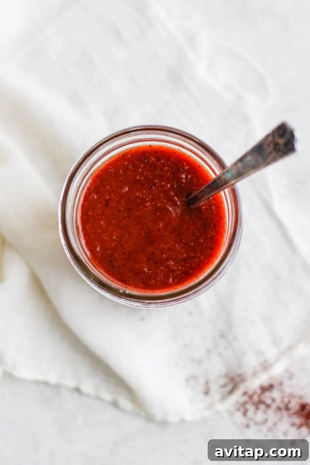 Close-up of glossy, rich homemade enchilada sauce in a bowl, ready to serve