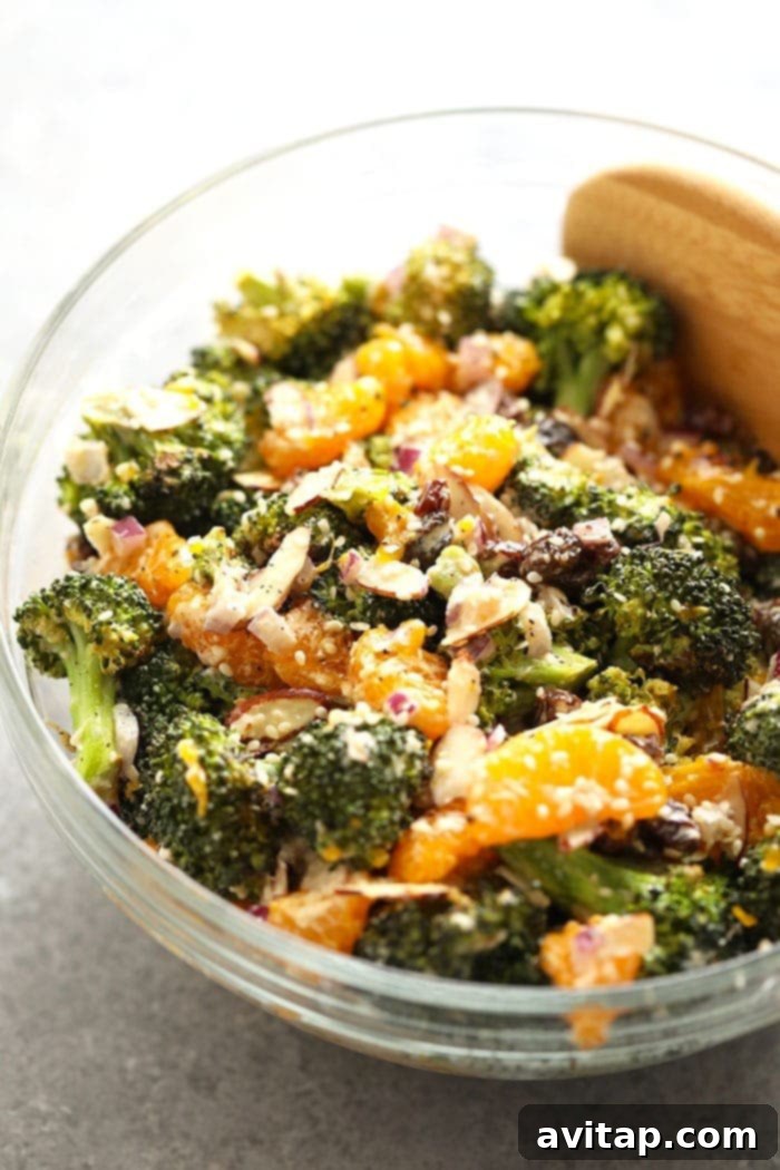 Vibrant Vegan Mandarin Orange Broccoli Salad in a large serving bowl, garnished with sesame seeds and fresh mandarin slices.