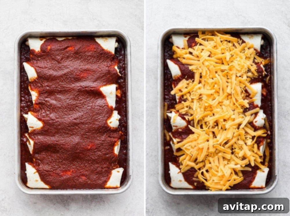 A baking dish filled with delicious rotisserie chicken enchiladas, covered in red sauce and a generous layer of shredded cheese, ready for the oven.