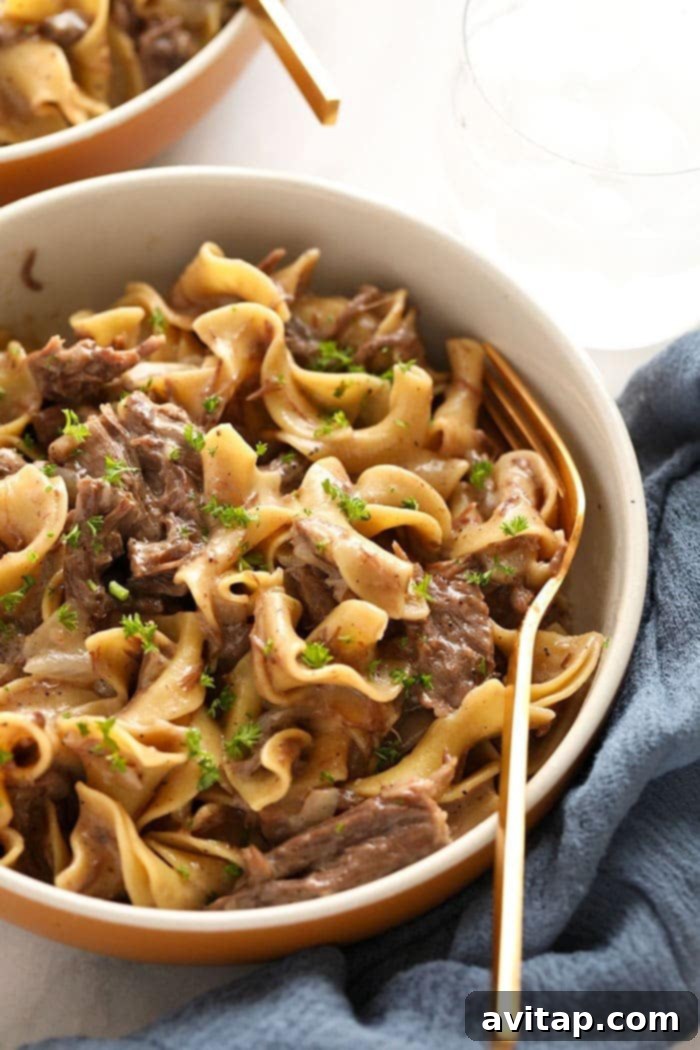 Instant Pot Beef Stroganoff in a serving bowl, garnished.