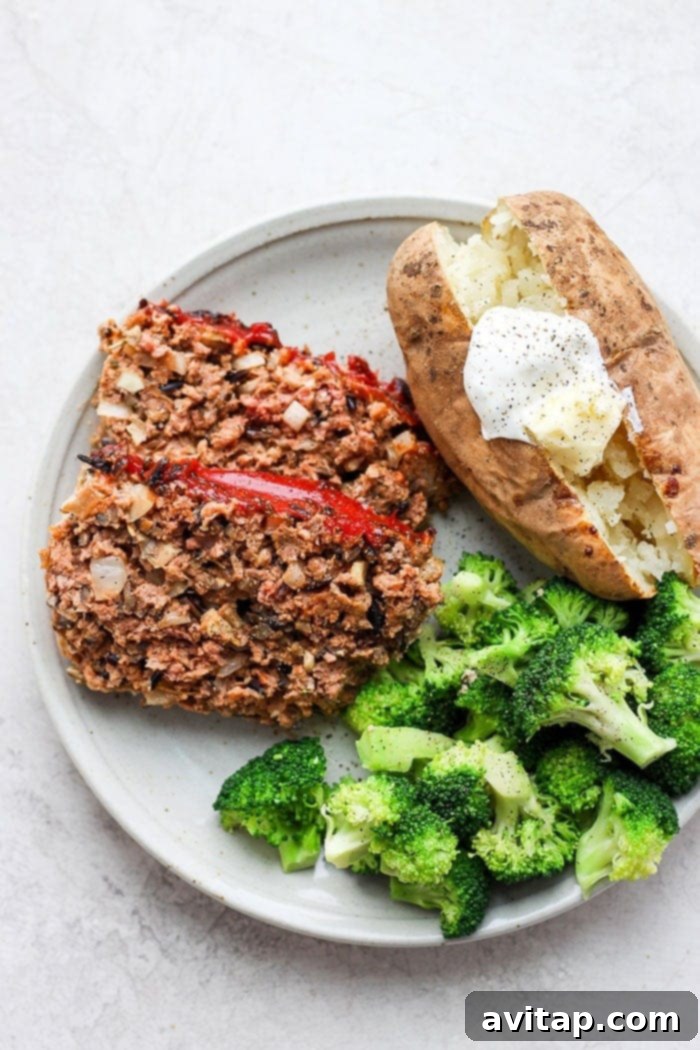 Served Wild Rice Meatloaf on a plate with baked potato and broccoli