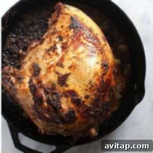 Perfect Sous Vide Turkey 7 Sous Vide turkey being seared in a cast iron skillet for a golden crust.