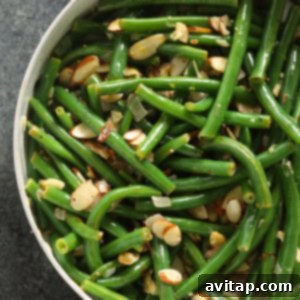 Green Beans Almondine being sautéed in a skillet.