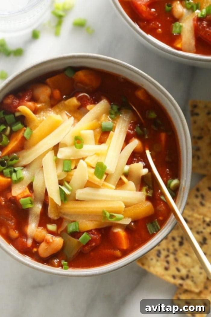 Vegetarian chili with melted cheese Close-up of hearty vegetarian chili topped with a generous layer of melted cheese.