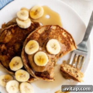 Peanut butter banana pancakes neatly arranged on a plate.