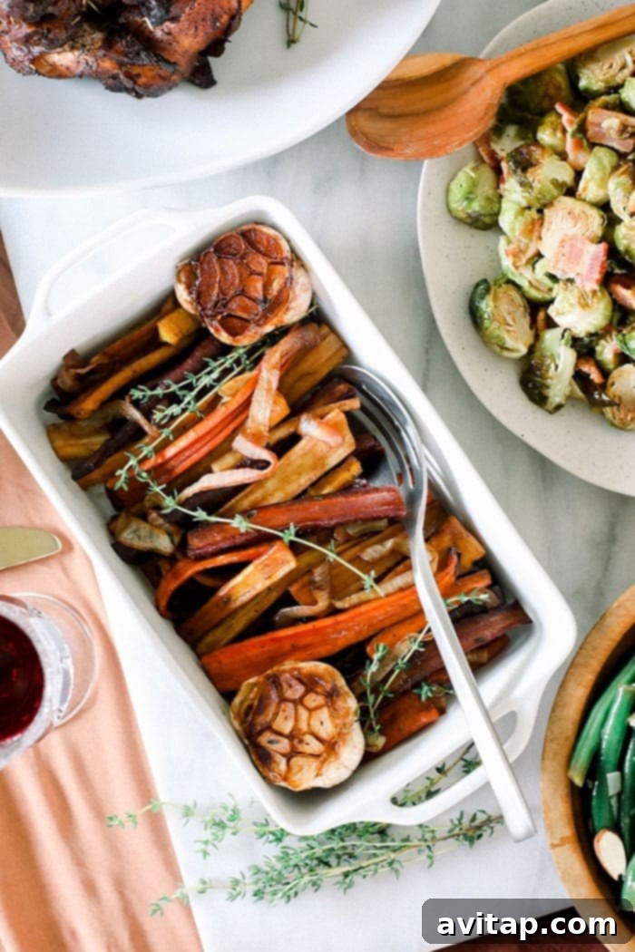 These Honey Balsamic Roasted Carrots are the ultimate holiday side dish! The combination of sweet and savory from the honey balsamic + perfectly roasted carrots, onions and garlic make this side a perfect addition to any holiday table. A festive holiday table adorned with perfectly roasted carrots plated, ready for guests.