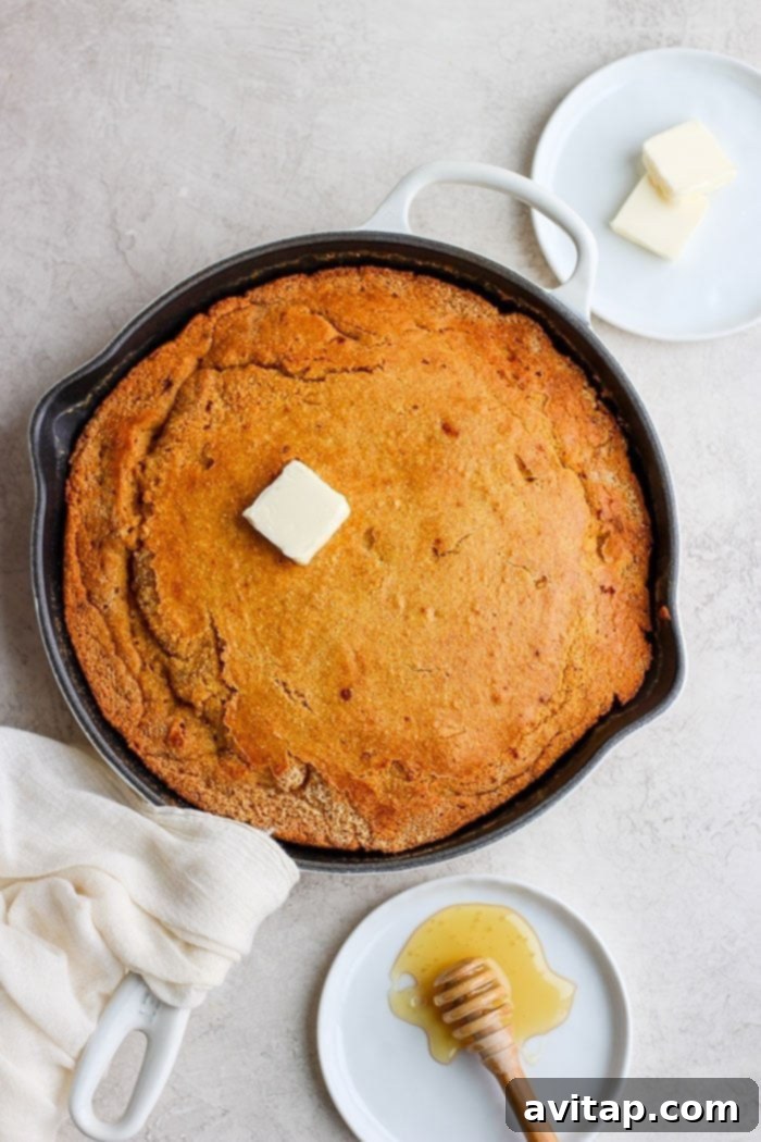 golden brown skillet cornbread with a slice cut out