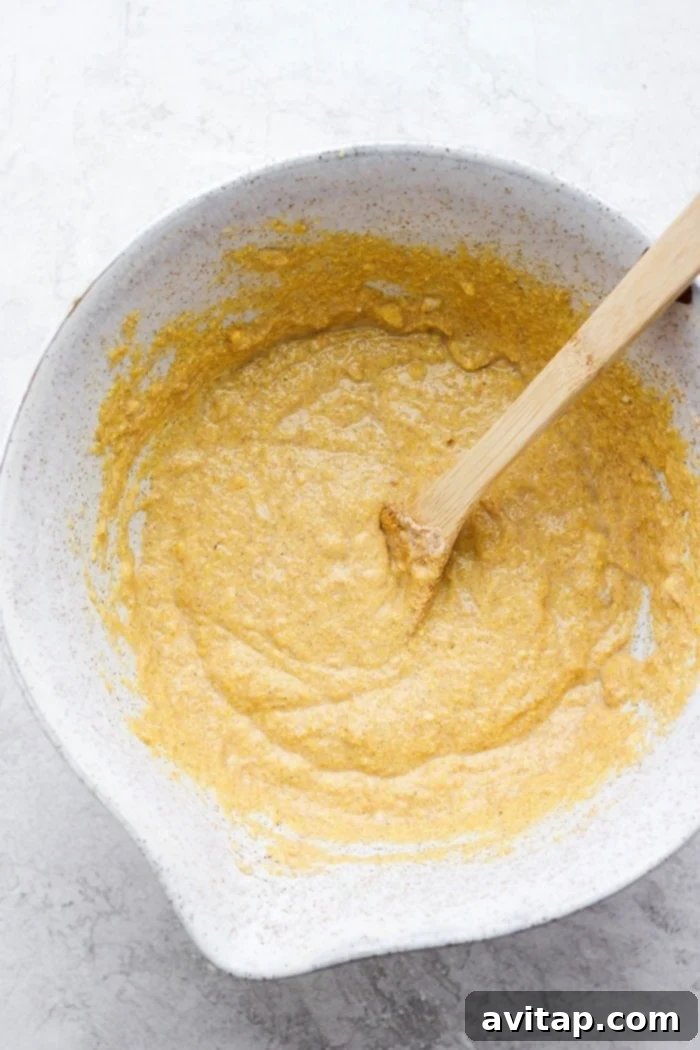 cornbread batter being mixed in a bowl