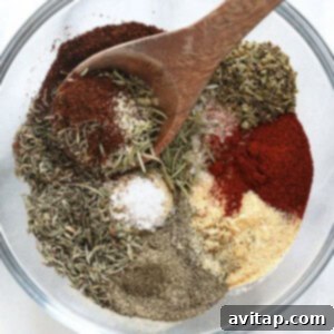 Spices in a bowl with a wooden spoon, perfect for flavorful turkey seasoning.