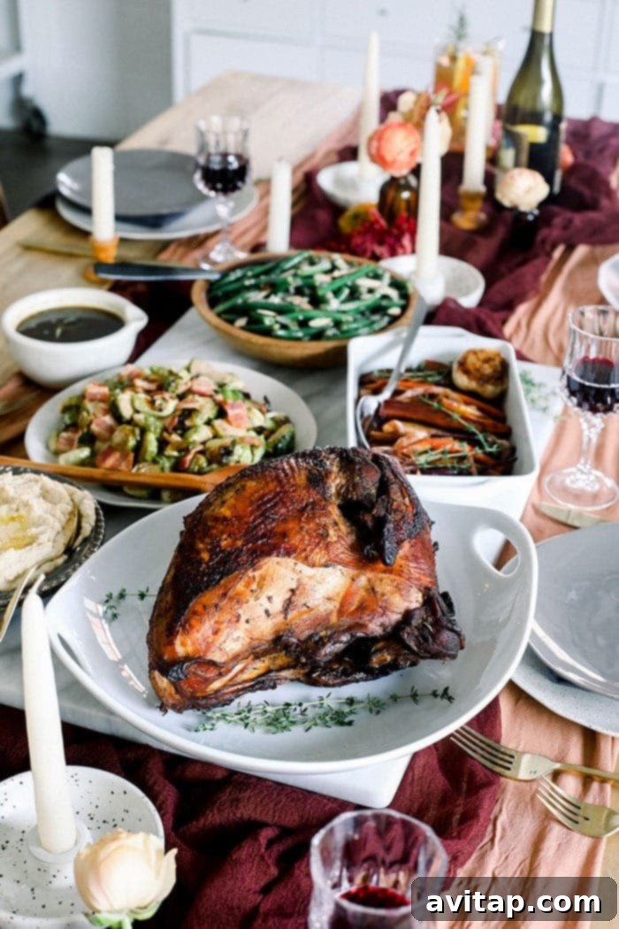 The holidays look a little bit different for everyone. One way you can celebrate is by throwing a Friendsgiving party - Friends + Thanksgiving! A perfectly roasted turkey, golden brown and garnished with fresh herbs, sits as the majestic centerpiece on a festive Friendsgiving table, ready to be carved.