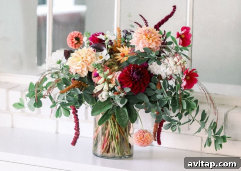The holidays look a little bit different for everyone. One way you can celebrate is by throwing a Friendsgiving party - Friends + Thanksgiving! A lush, colorful floral bouquet from Flower Child Farm, showcasing the beauty of seasonal flowers as simple Friendsgiving decor.