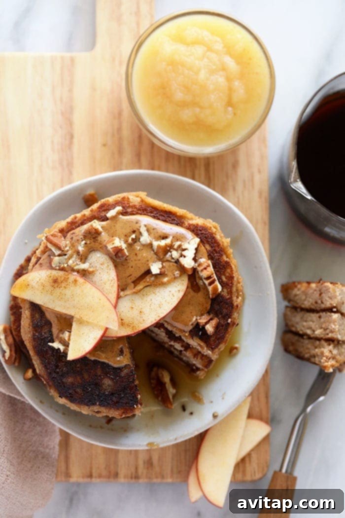 A stack of golden applesauce pancakes on a clean plate, inviting toppings and ready to be enjoyed as a healthy meal.
