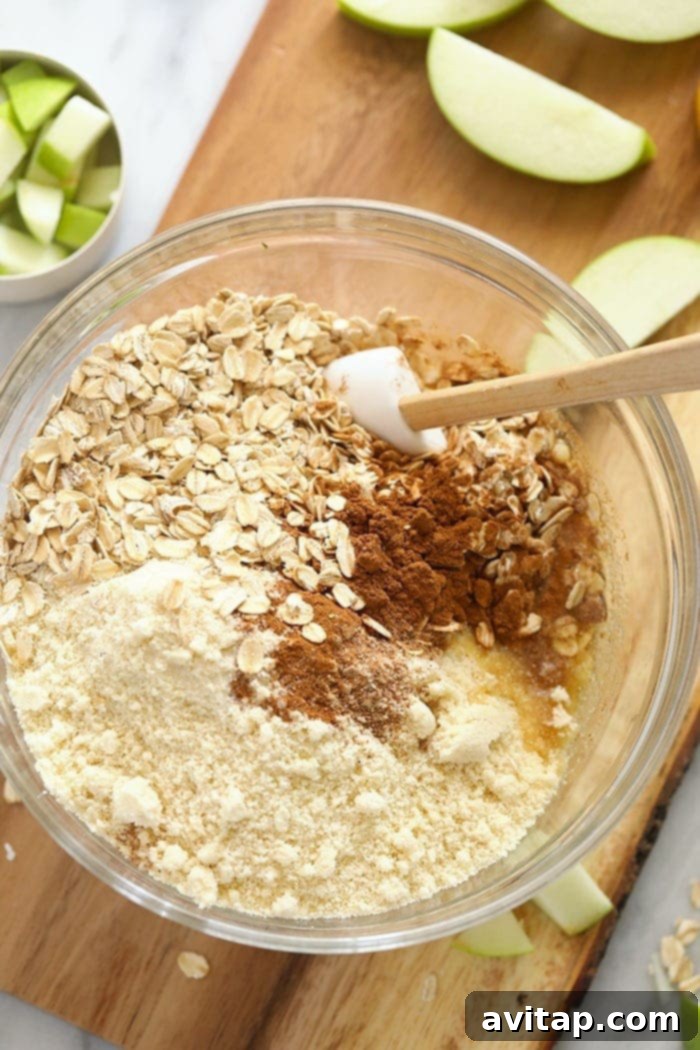 Preparing the gluten-free sugar cookie crust in a mixing bowl for apple pie bars.