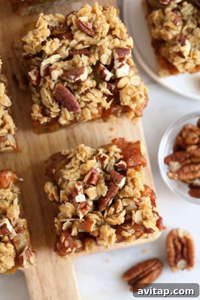 Gluten-free apple pie bars artfully arranged on a rustic cutting board, ready to be served.