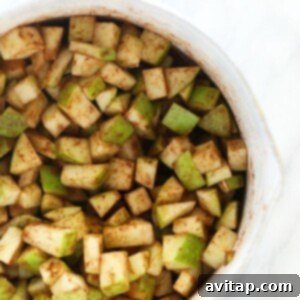 Sliced apples arranged in a white bowl, perfect for making apple pie bars.