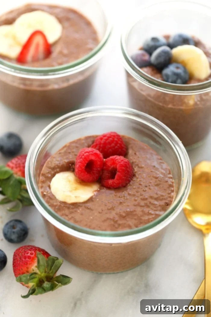 Close-up of thick protein chia seed pudding in a glass cup, showcasing its creamy texture.