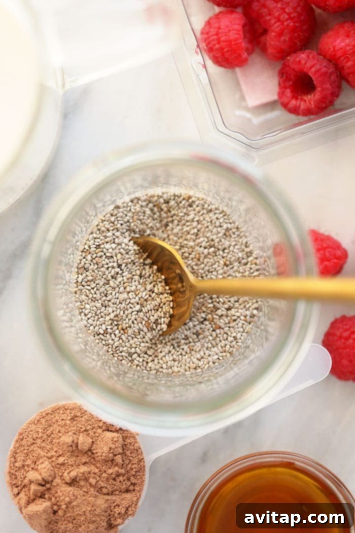 Close-up of white chia seeds in a transparent cup, ready to be prepared into a delicious pudding.