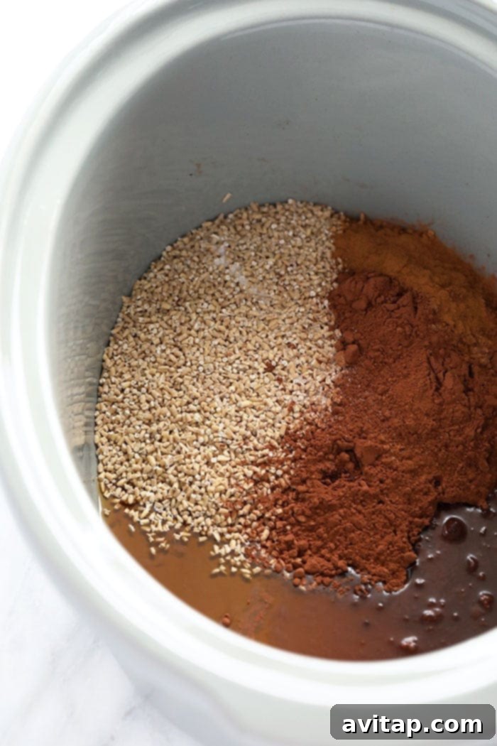 Gathering Ingredients for Slow Cooker Hot Cocoa Steel Cut Oats Ingredients for hot cocoa steel cut oats gathered in a slow cooker, ready to be mixed.