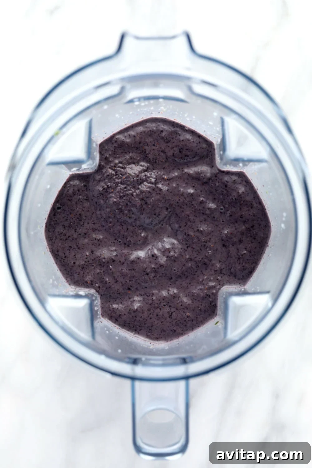 A freshly blended blueberry superfood smoothie, ready to drink.