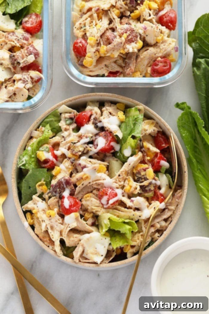 A beautifully arranged Rotisserie Chicken Cobb Salad in a large bowl, showcasing all its fresh ingredients.