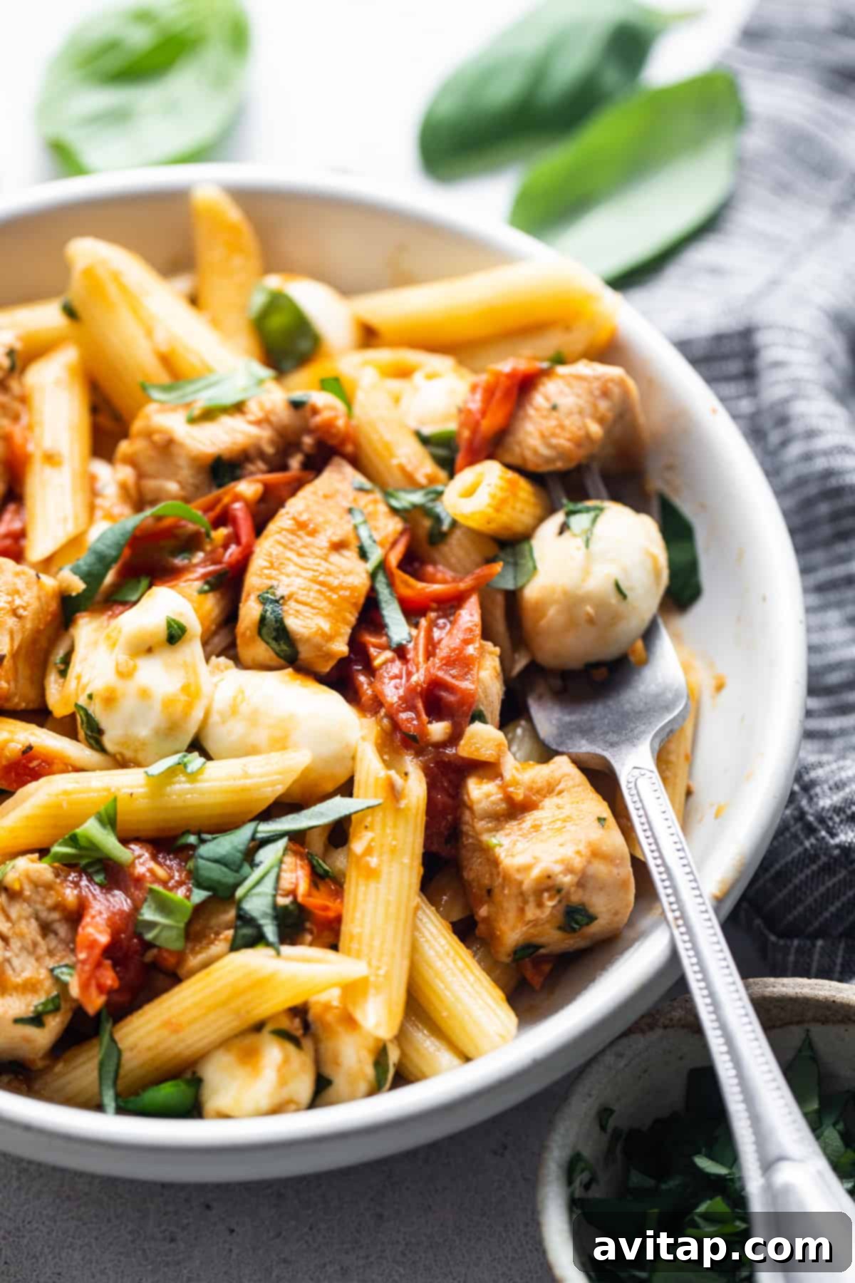 A perfectly portioned bowl of delicious chicken Caprese pasta, ready to serve.