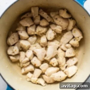 Cooking chicken pieces in olive oil in a large pot until lightly browned.