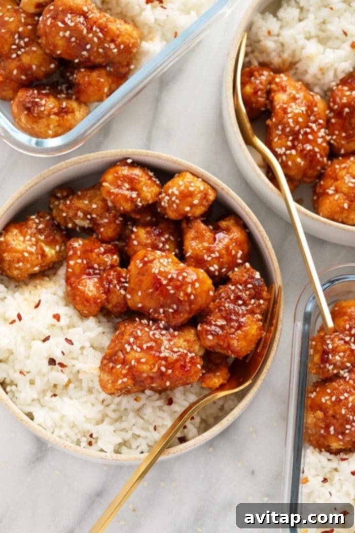 Delicious and crispy General Tso's Cauliflower, garnished with sesame seeds and green onions, ready to be served.