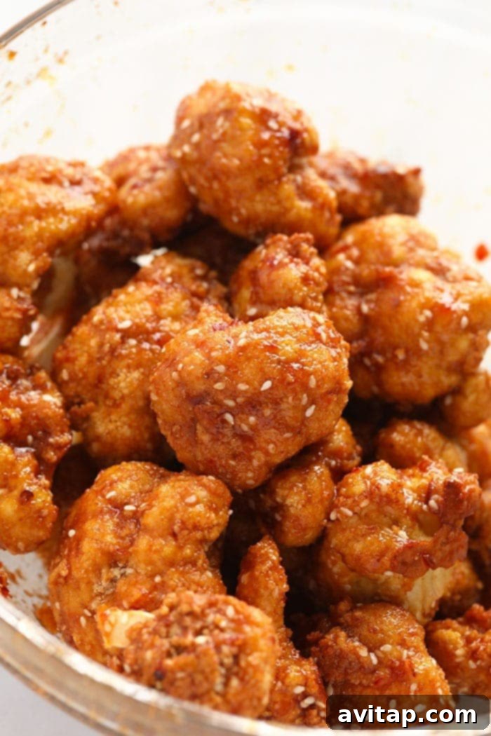 Perfectly coated General Tso's Cauliflower ready to be served General Tso's Cauliflower coated in a rich, sticky sauce in a clear glass bowl
