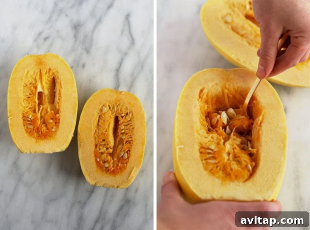 Expertly scooping out the seeds and stringy pulp from a spaghetti squash half