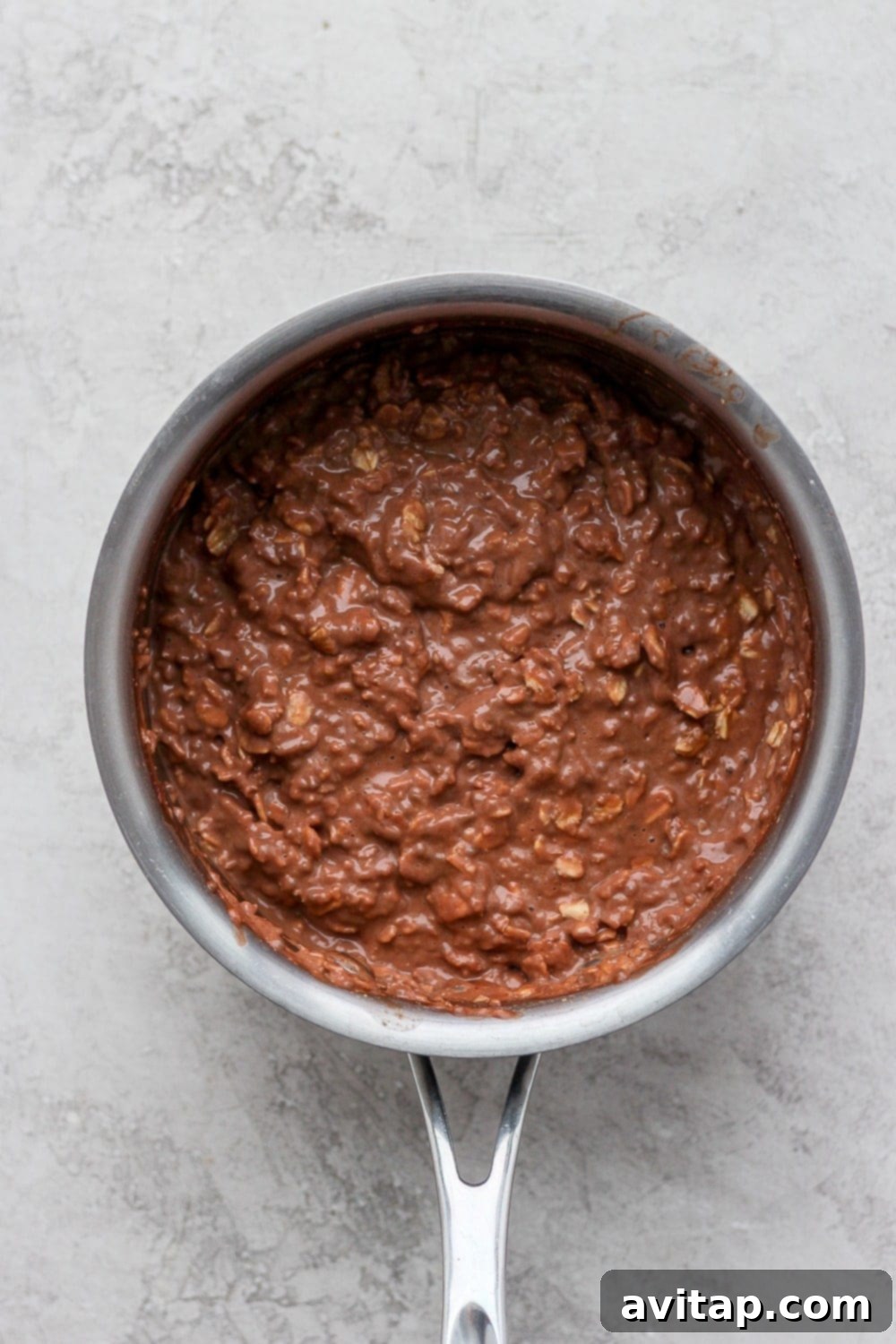 Your perfectly cooked Chocolate Sea Salt Protein Oatmeal, steaming and ready for toppings. A pot of perfectly cooked chocolate sea salt protein oatmeal, creamy and ready to be served.