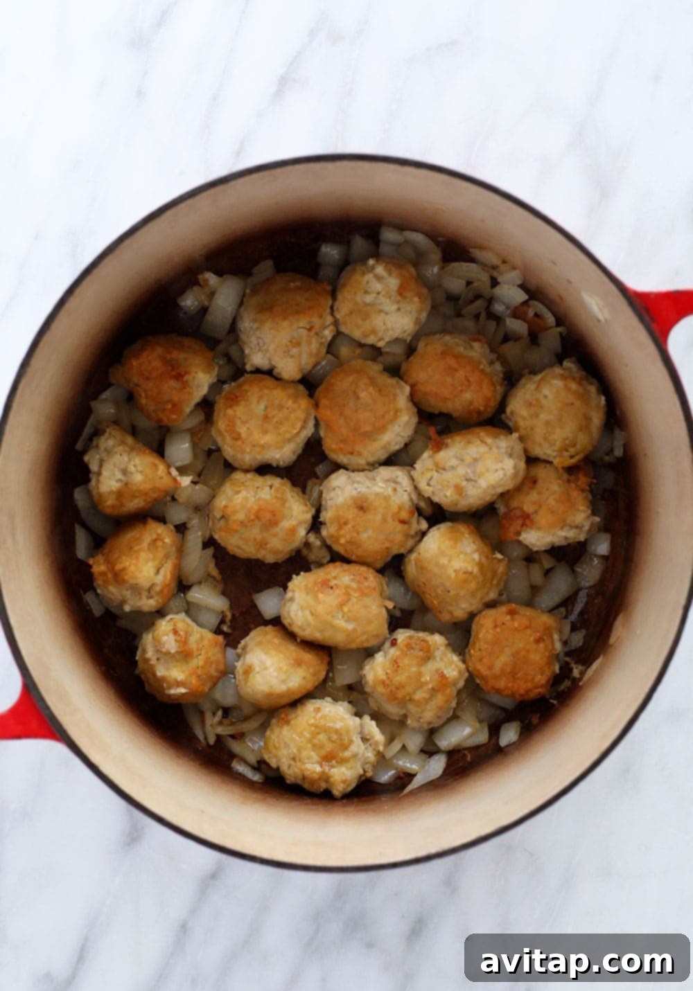 Hello, tikka masala meatballs! Enjoy a bowl of these tikka masala meatballs over a bed of rice, quinoa, or roasted veggies! You can make it for dinner or for a great meal prep dinner for the week! Browning meatballs in a dutch oven